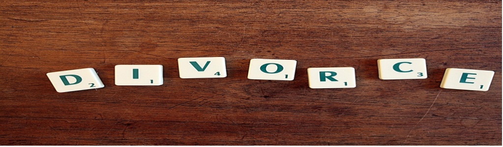 Game tiles with letters and numbers arranged to spell out “DIVORCE.”