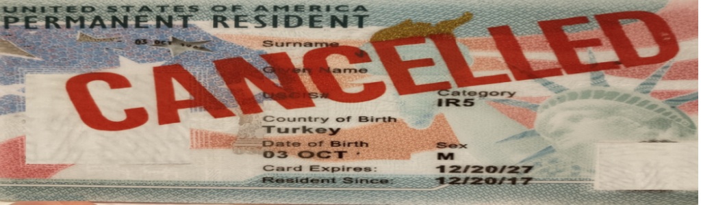A green card image marked “CANCELLED,” representing revoked or suspended immigration status.